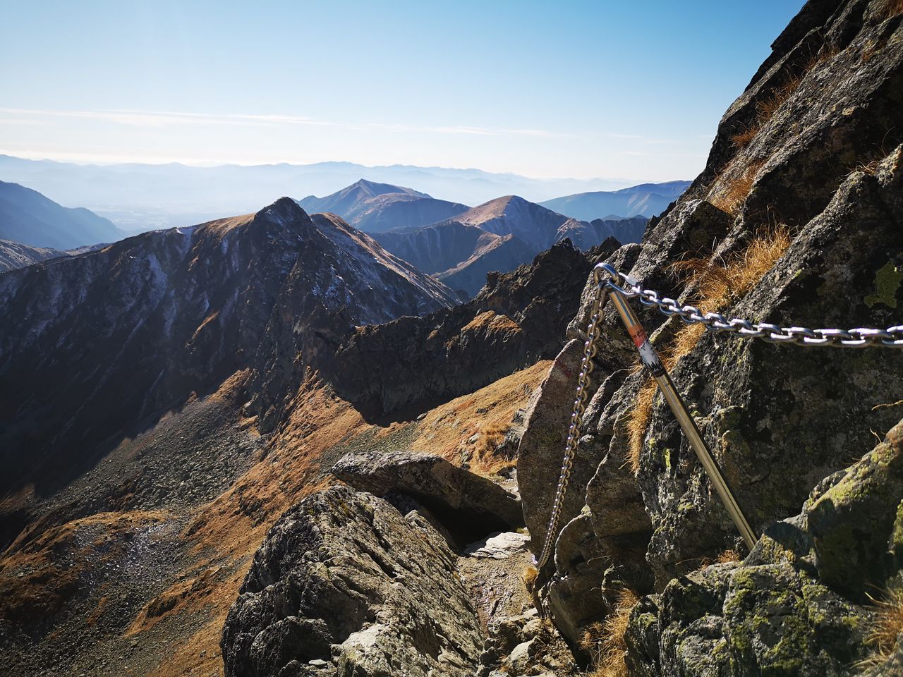 Breathtaking view of a rugged mountain trail in the High Tatras during autumn. Crisp air and clear skies.